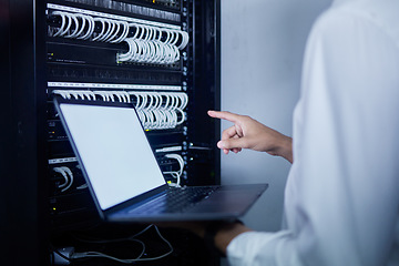 Image showing Laptop, pointing hand and server room person, technician or programmer problem solving cloud computing network. Cybersecurity, mockup screen and closeup worker troubleshooting cable system connection