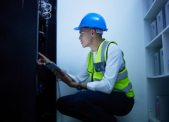 Image showing Man, engineering and tablet for power maintenance, server room or data center inspection in IT cybersecurity. Young, electrician person on digital tech for network programming, electricity and cables