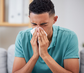 Image showing Man blowing nose, sick with virus and health with hayfever, medicine with cold or flu while at home. Young male person, allergy and sinus, healthcare and wellness, infection and illness with bacteria