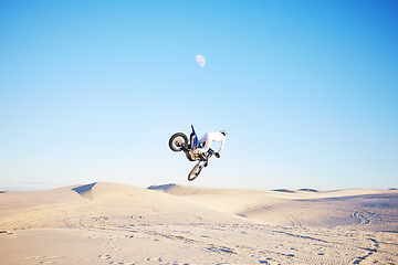 Image showing Desert, motorbike jump or sports person travel, agile or driving on off road adventure, air freedom or bike journey. Motorcycle challenge, blue sky or extreme action driver, talent and skill training