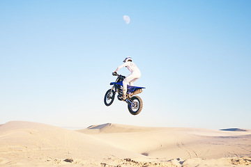 Image showing Sports, cycling and man on motorbike on sand for adrenaline, adventure and freedom in desert. Competition, extreme action and male person on bike on dunes for training, exercise and race or challenge