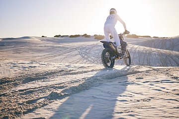 Image showing Desert, motorbike and back of sports person travel, transport and driving on challenge adventure, freedom and training. Nature sunset, extreme action and athlete ride motorcycle on sand dunes hill