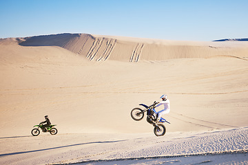 Image showing Bike, sand and freedom with people in the desert for adrenaline, adventure or training in nature. Moto, sports and balance with friends on dirt in summer for a race competition or training on space