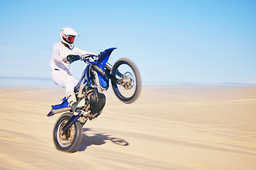 Image showing Bike, sand and motion blur with a man in the desert for adrenaline, adventure or training in nature. Energy, speed and balance with a male sports athlete riding a motorcycle in a remote location