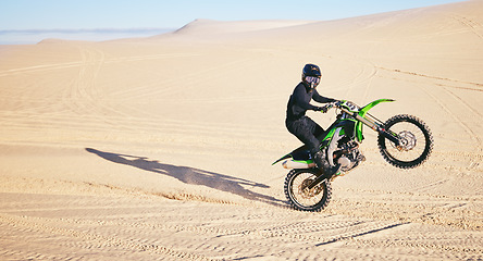 Image showing Motorcycle, sand and space with a man in the desert for adrenaline, adventure or training in nature. Energy, summer and balance with an athlete riding a bike for sports training in a remote location