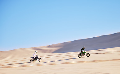 Image showing Bike, sand and race with people in the desert for adrenaline, adventure or training in nature. Sports, energy and freedom with friends in a remote location for a motorcycle competition in Dubai