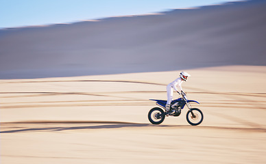 Image showing Bike, training and space with a man in the desert for fitness or an adrenaline hobby for freedom. Motorcycle, sports and summer with a male athlete riding a vehicle in Dubai for energy or balance