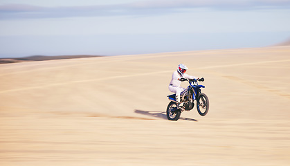 Image showing Race, motorcycle and person in desert, action and extreme sport with speed, riding outdoor and mockup space. Adventure, fitness and training, motorbike exercise and freedom, challenge and performance