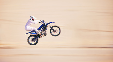 Image showing Race, motorbike stunt and person in desert, action and extreme sport, speed riding outdoor and mockup space. Adventure, fitness and train, motorcycle exercise and freedom, challenge and performance