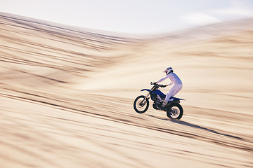 Image showing Motorcycle, sports and space with a man in the desert for fitness or an adrenaline hobby for freedom. Bike, training and summer with a male athlete riding a vehicle in Dubai for energy or balance