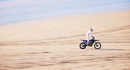 Image showing Bike, sports and space with a man in the desert for fitness or an adrenaline hobby for freedom. Motorcycle, training and summer with a male athlete riding a vehicle in Dubai for energy or balance