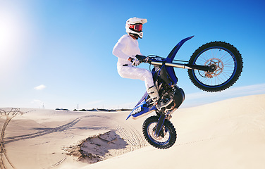 Image showing Jump, sports and man on motorcycle on sand for adrenaline, adventure and freedom in desert. Action, extreme motorbike and male person on bike on dunes for training, exercise and race or challenge