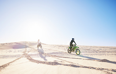 Image showing Bike, sports and race with people in the desert for fitness or an adrenaline hobby for freedom. Motorcycle, training and summer with athlete friends riding a vehicle in Dubai for energy or balance