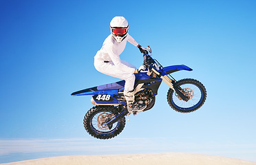 Image showing Blue sky, motorbike in air and person with action and extreme sport, speed outdoor and mockup space. Adventure, fitness and training, motorcycle jump stunt and freedom, challenge and performance