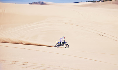 Image showing Bike, sports and speed with a man in the desert for a fitness, freedom or an adrenaline hobby. Motorcycle, training and summer with a male athlete riding a vehicle in Dubai for energy on space