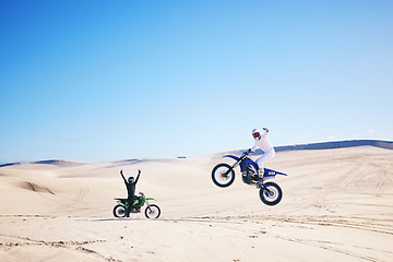 Image showing Bike, winner and motivation with people in the desert for fitness or adrenaline while training. Motorcycle, support and celebration with athlete friends cheering a jump in Dubai for energy or freedom