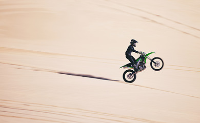 Image showing Bike, sports and balance with a man in the desert for fitness or an adrenaline hobby on space. Motorcycle, training and summer with a male athlete riding a vehicle in Dubai for freedom or energy