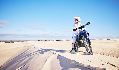 Image showing Desert sky, motorcycle or extreme sports person looking at outdoor view, Dubai nature or off road sand dunes. Mockup, freedom or athlete driver, racer or expert rider ready for bike cycling challenge