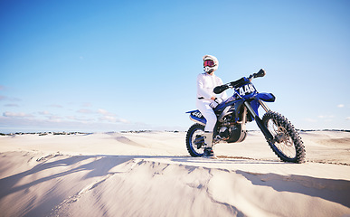 Image showing Sand, motor sports and man with motorbike for adrenaline, adventure and freedom in desert. Action, extreme challenge and male person on bike on dunes for training, exercise and race or competition