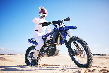 Image showing Sand, motor sports and man drive with motorbike for adrenaline, adventure and freedom in desert. Action, extreme sport and male person on bike on dunes for training, exercise and race or challenge