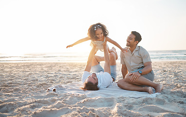 Image showing Lgbt family on beach, men with child and flying game on blanket for island holiday together in Hawaii. Love, play and sun, happy gay couple on tropical ocean vacation and parents with girl on sand.