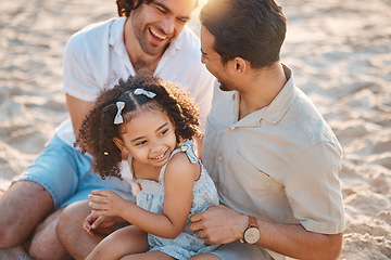 Image showing Gay men, father and girl at beach with love, bonding and care for vacation, laughing and outdoor in sunshine. LGBT couple, young daughter and adoption for family, holiday and happy together in summer