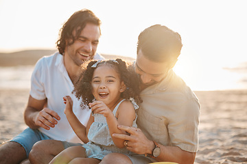 Image showing Gay father, family and girl at beach with love, smile and hug for vacation, laugh and outdoor on sand in sunset. LGBTQ men, young kid and adoption with parents, holiday and comic tickling in summer