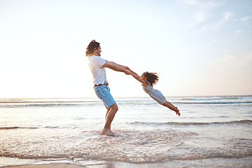 Image showing Father, spin girl child and beach with games, holding hands or happy for bonding together by waves. Dad, female kid and swing with love, care and playing by sea, ocean or family on vacation in summer