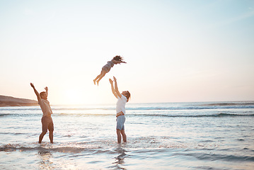 Image showing Father, lifting and child in air at beach, sunset and waves in the ocean for happiness, fun and support on adventure. Parents, kid and silhouette of dad in the sea with love to play a game with girl