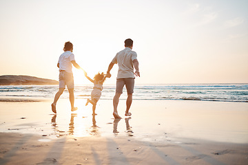 Image showing Love, gay couple and men with child on beach, holding hands and island holiday together. Trust, happiness and sun, lgbt family on tropical ocean vacation with daughter in playing in waves with nature