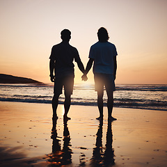 Image showing Silhouette, holding hands and gay couple on beach, sunset and shadow on summer vacation together in Thailand. Sunshine, ocean and romance, lgbt men in nature and fun holiday with pride, sea and waves