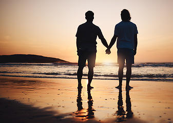 Image showing Silhouette, holding hands and gay couple on beach, sunset and nature on summer vacation together in Thailand. Sunshine, ocean and romance, lgbt men on island and fun holiday with pride, sea and waves