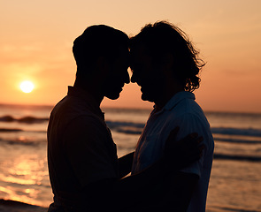 Image showing Silhouette, sunset and gay men on beach, love and shadow on summer island vacation together in Thailand. Sunshine, ocean and romance, lgbt couple in nature and fun holiday with pride, sea and waves.