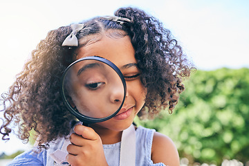 Image showing Girl child, magnifying glass and inspection in garden, backyard or park in science, study or outdoor. Young female kid, lens and zoom for nature, search or check for plant, leaves or growth in summer