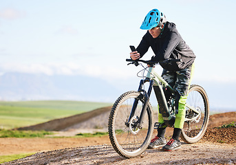 Image showing Fitness, nature and man cycling with phone for direction, social media or reading a notification. Sports, communication and cyclist or person on a bike with a mobile app for progress in the mountains