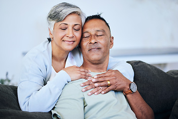 Image showing Love, romance and a senior couple on a sofa in the living room of their home together during retirement. Happy, relax and hug with an elderly woman embracing her husband for comfort in a house