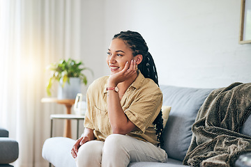 Image showing Happy, African woman and thinking in home about interior design, decoration or idea in apartment, living room or house. Girl, relax and lounge on sofa with inspiration, goals or peace in life