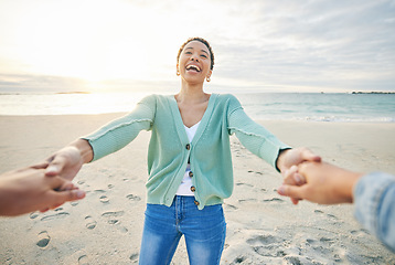 Image showing Couple, pov and holding hands on beach for love with people outdoor at sunset together. Nature, spinning and funny with a happy woman laughing on the sand on a fun date for summer holiday and travel