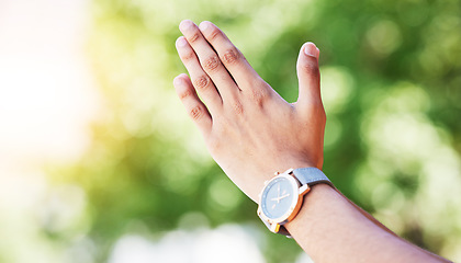 Image showing Hand, time and watch with a person outdoor in nature on a green background for freedom, meditation or zen. Yoga, fitness and wellness with an adult alone in the park, garden or backyard closeup