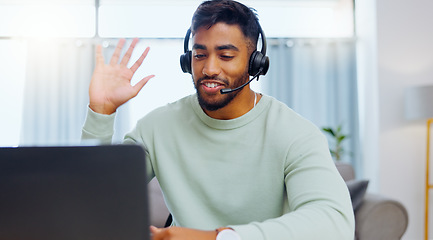 Image showing Video call, black man and work from home, virtual communication or remote client tech support in call center career. Hello, wave of indian person, agent or consultant in living room on laptop talking