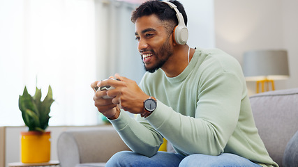 Image showing Gaming, winner and esports with a man in the living room of his home, playing a video game for fun. Winning, celebration and next level with a gamer using a joystick controller to play console games