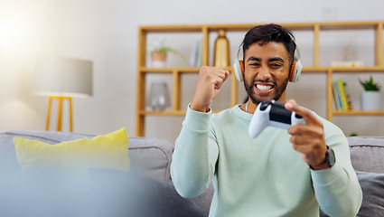 Image showing Gaming, winner success and esports with a man in the living room of his home, playing a video game for fun. Winning, celebration and next level with a gamer using a joystick controller to play consol