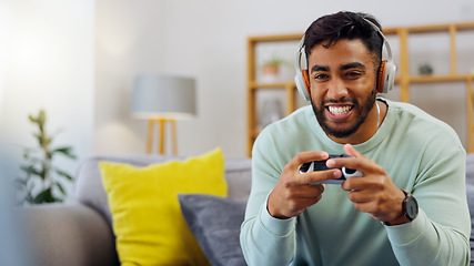 Image showing Gaming, winner and esports with a man in the living room of his home, playing a video game for fun. Winning, celebration and next level with a gamer using a joystick controller to play console games