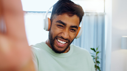 Image showing Selfie, man and smiling with headphones for music playlist streaming and cheerful mood in home. Wellness laughing, audio and happy male ready to dance photograph with smile.