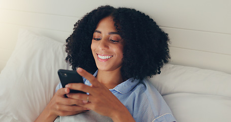 Image showing Phone, happy woman and bed of a young female texting on a social media app in the morning. Wifi, web networking and happiness of a young person with a smile in a house writing a text in a chat