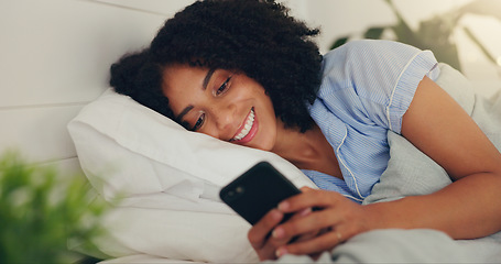 Image showing Phone text, happy woman and bed of a young female texting on a social media app in the morning. Wifi, web networking and happiness of a young person with a smile in a house reading a message