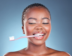 Image showing Happy black woman, toothbrush and teeth in dental cleaning or care against a studio background. Face of African female person smile in morning routine tooth whitening, oral or mouth and gum hygiene