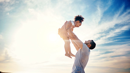 Image showing Father lifting kid, air and blue sky with family, travel and freedom outdoor, bonding and ocean with girl and man. Happy people, sunshine and tropical vacation, child flying with dad and adventure