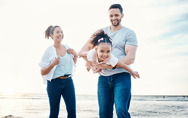 Image showing Beach, father and child, airplane and mother with travel, happy family on holiday with energy and playing together. Ocean, adventure and freedom, parents and girl kid flying, happiness and bonding