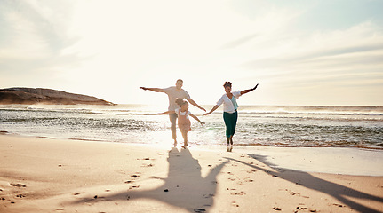 Image showing Family, running and freedom on beach with sunshine, happiness and fun together, games and bonding on vacation. Travel, adventure and playful, parents and child, happy people in nature with energy